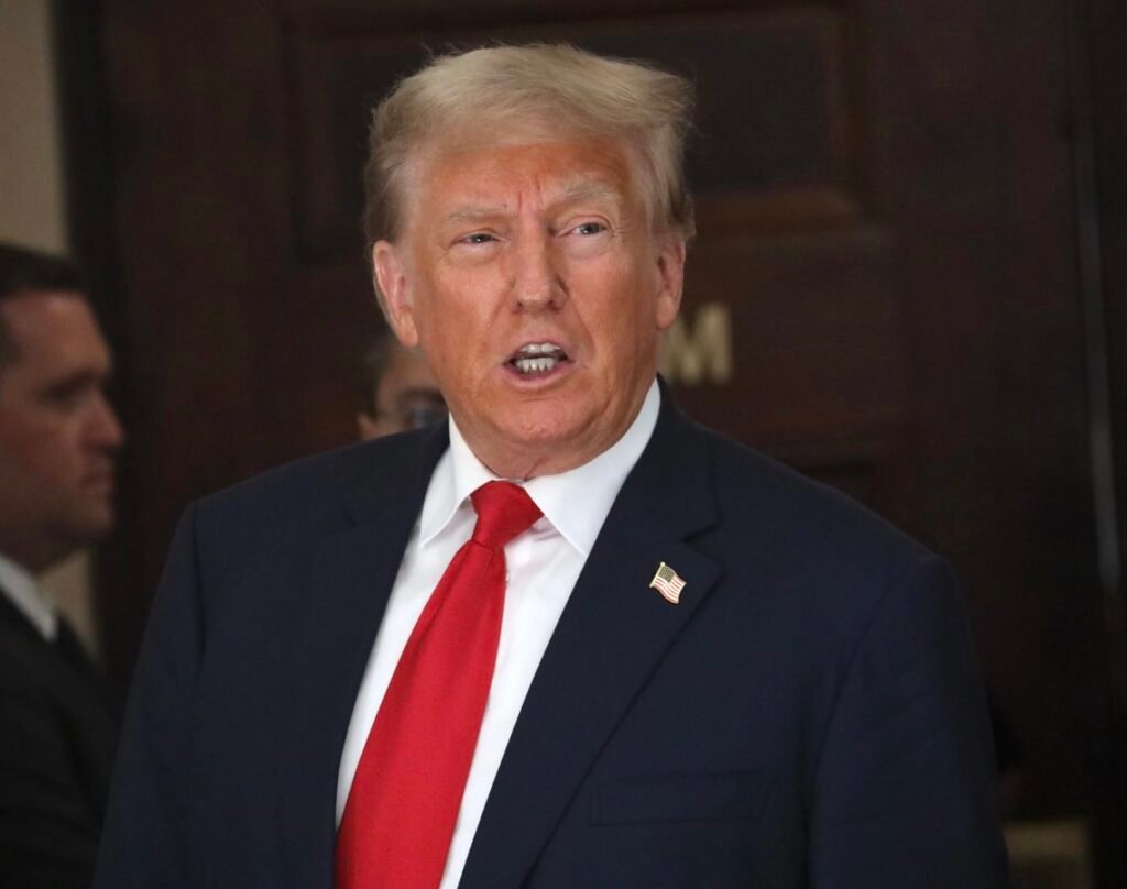 Yellow tape marked with the word TARIFFS restricts access to shipping containers