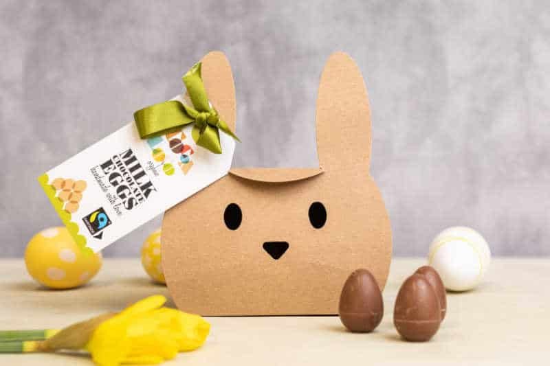 The UK Ethical Easter Eggs To Know In 2026 Cardboard box in the shape of a bunny with chocolate eggs.