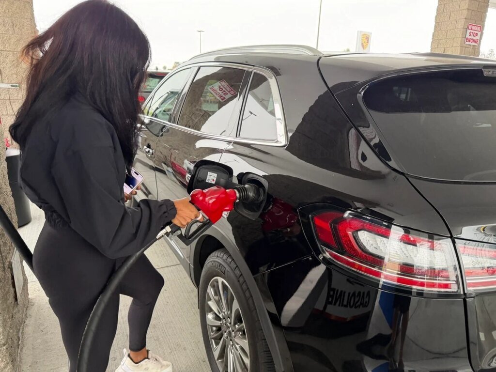 Why I Like SIXT’s $49.99 Fuel Deal for Summer Road Trips – Woman filling the car up with gas